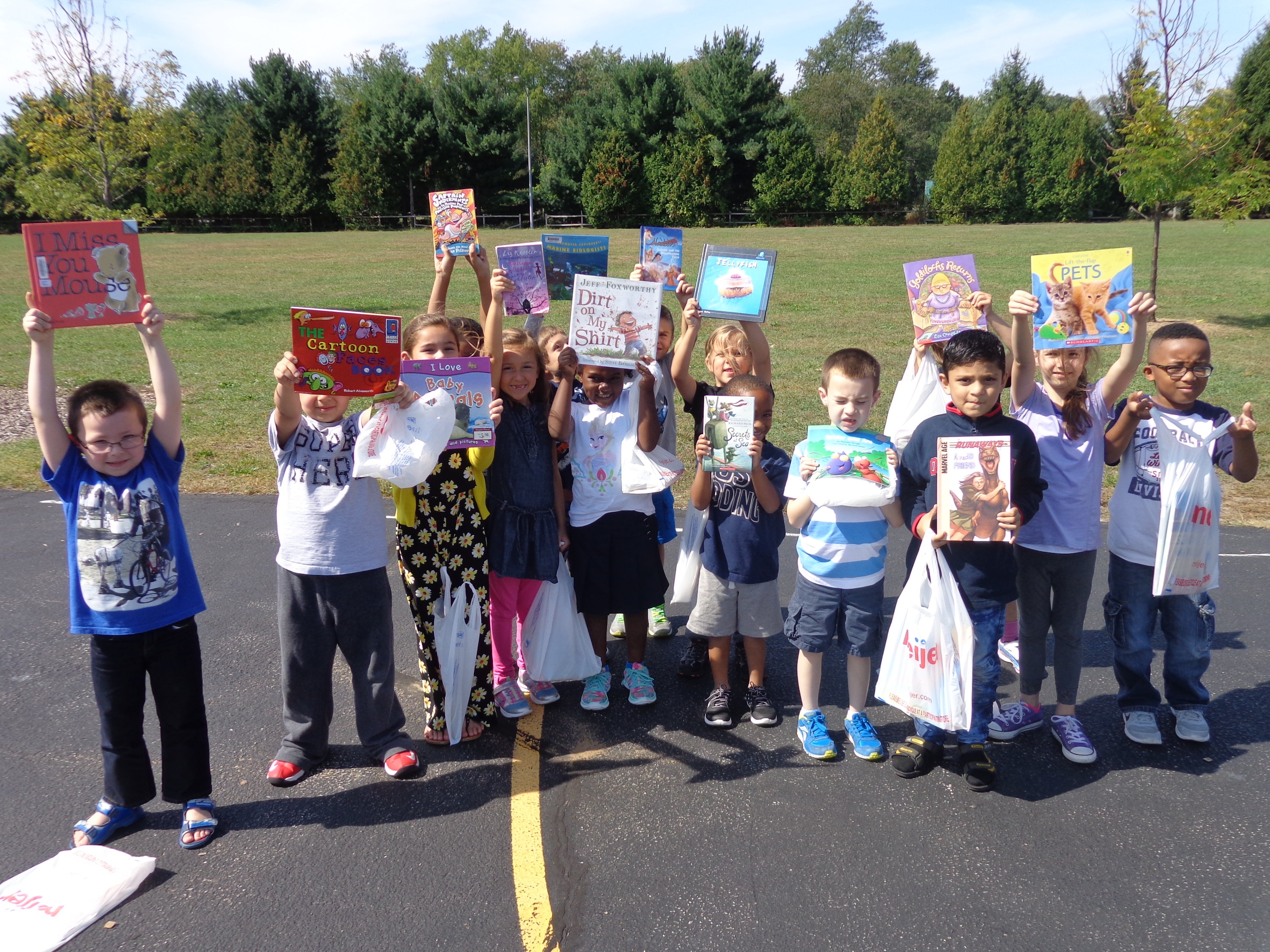 Students at Walt Disney Elementary show off the books they picked out.